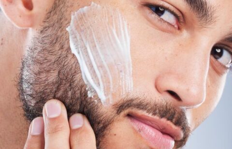 Cream, skincare and face of man in studio for beauty, wellness and facial treatment on white background. Dermatology, spa product and isolated person with moisturizer, lotion and anti aging cosmetics.